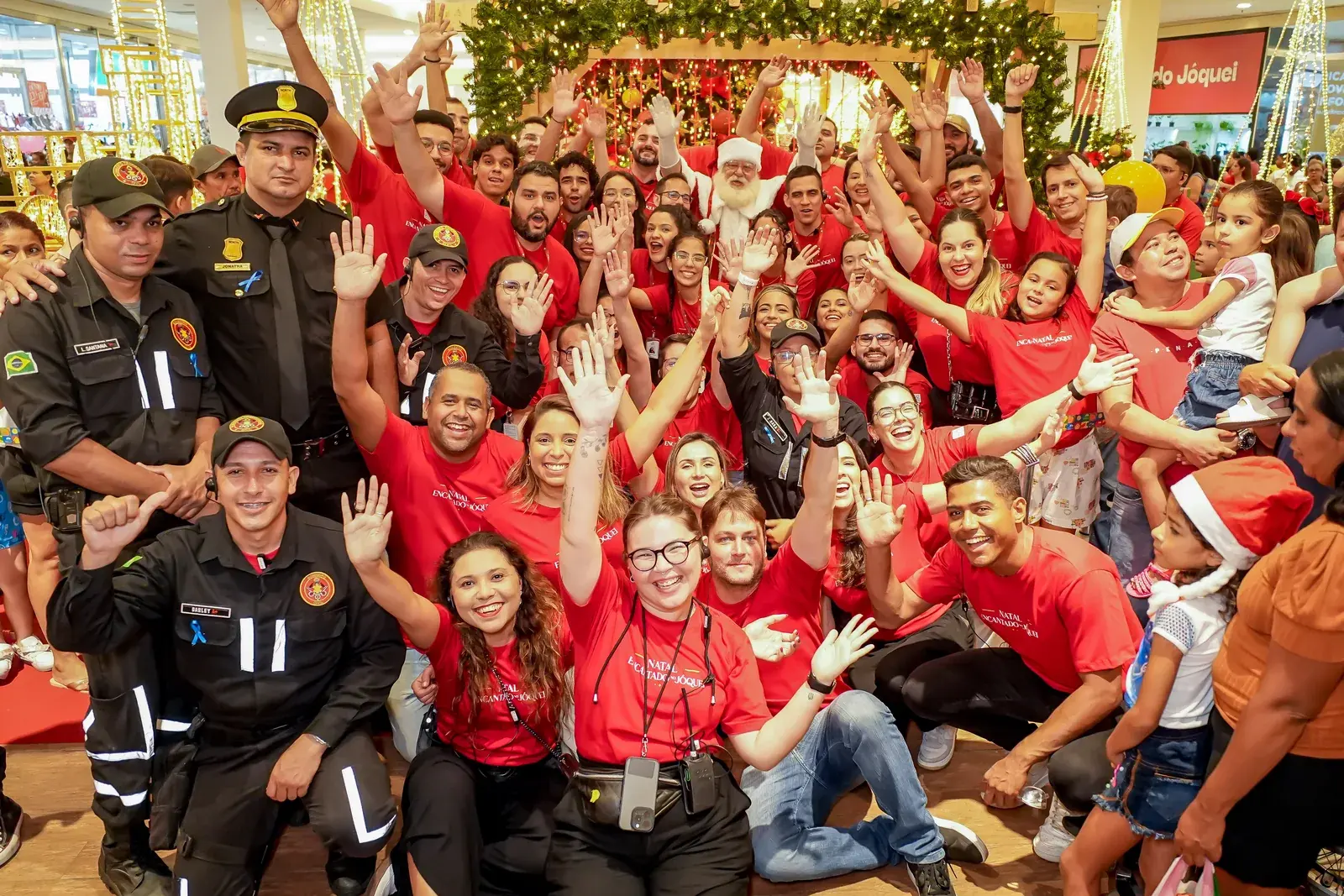The event team celebrates alongside the crowd dressed in red