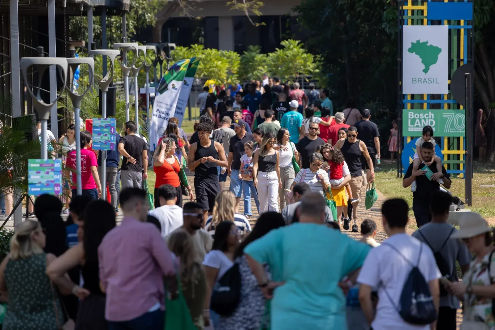 Visitors walk among the flags of the countries along the Boschland route